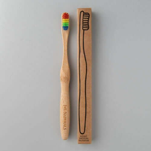 Bamboo toothbrush with rainbow colored bristles and its cardboard packaging