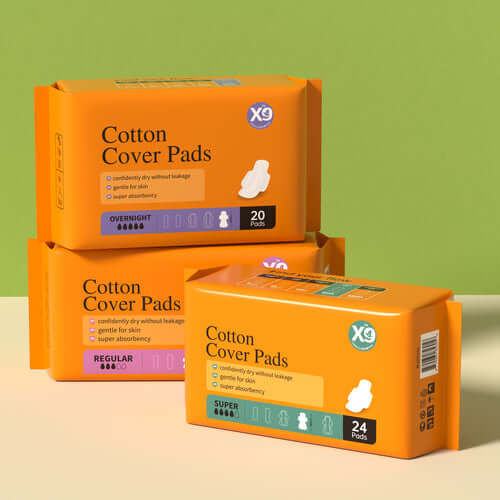 Three orange boxes of Cotton Cover Pads in overnight, regular, and super absorbency options.