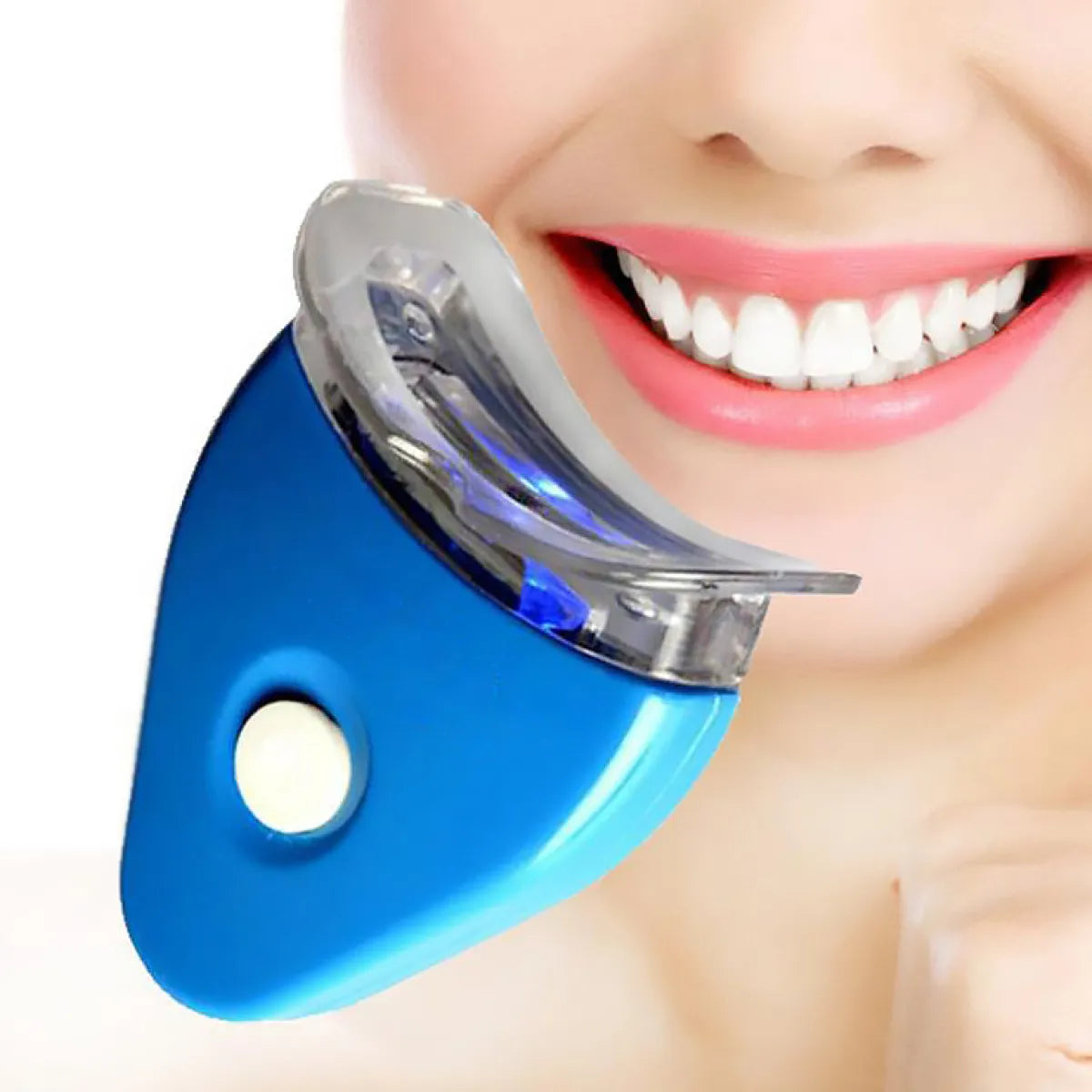 LED teeth whitening device held near a smiling mouth