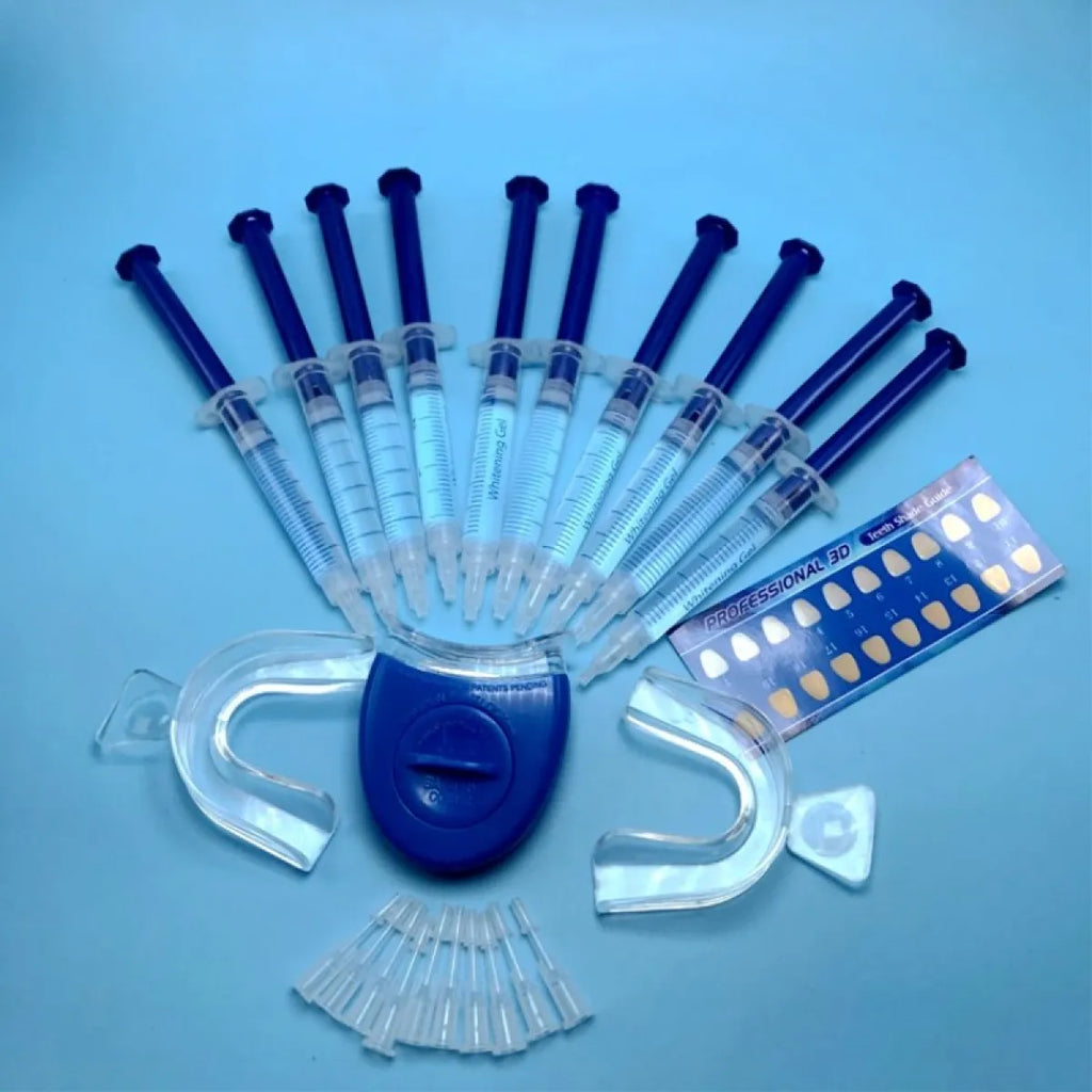 Professional teeth whitening kit with gel syringes, LED tray, and shade guide