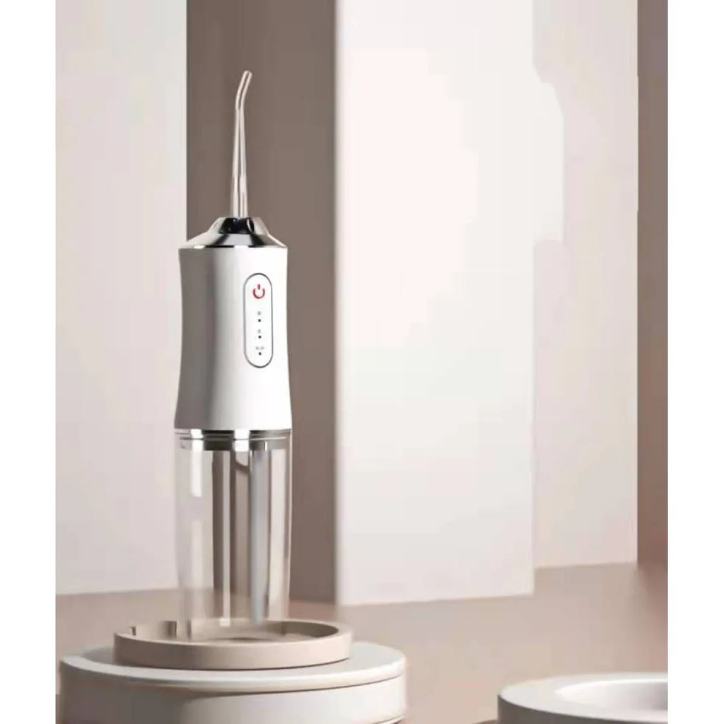 White cordless water flosser on bathroom counter