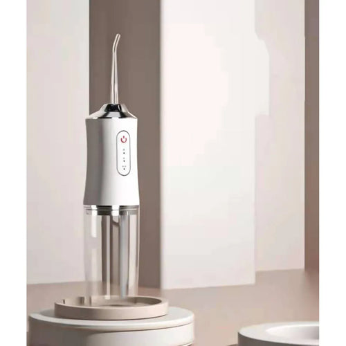 White cordless water flosser on bathroom counter